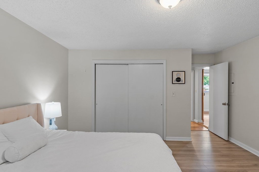 24 Algonquin Road Chelmsford, MA 01824 - Photo 25 of 38 a spacious bedroom with a bed and a wooden floor