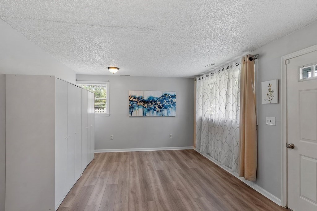 24 Algonquin Road Chelmsford, MA 01824 - Photo 26 of 38 a view of a room with wooden floor closet and windows
