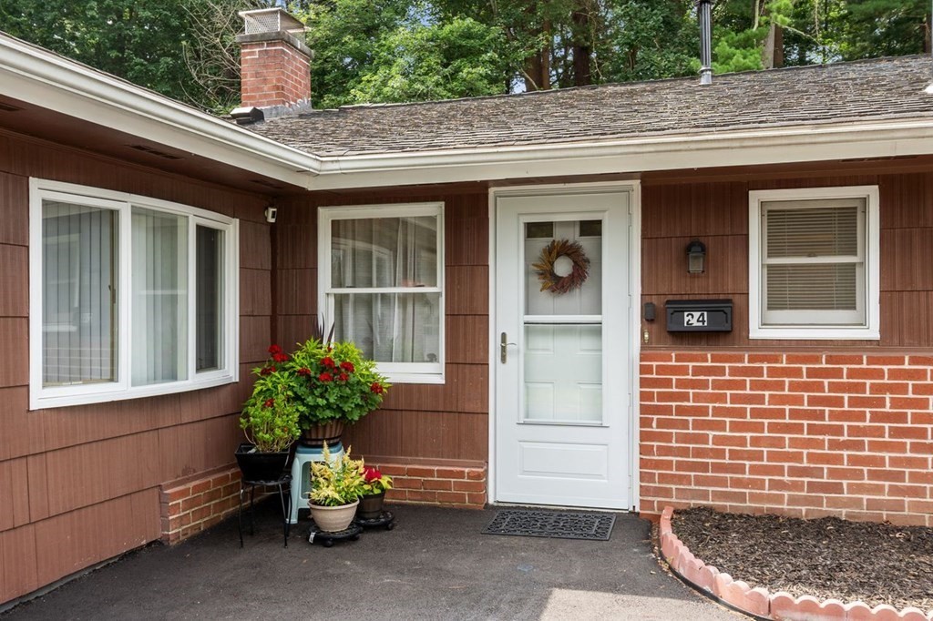 24 Algonquin Road Chelmsford, MA 01824 - Photo 5 of 38 a potted plant sitting in front of a house