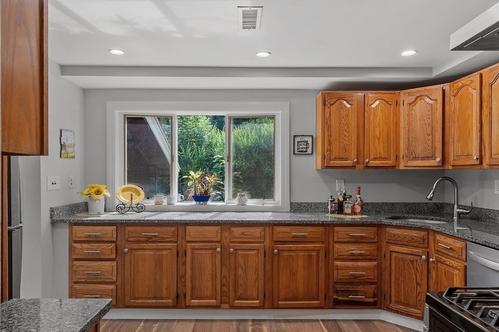 24 Algonquin Road Chelmsford, MA 01824 - Photo 9 of 38 a kitchen with granite countertop a sink and a window