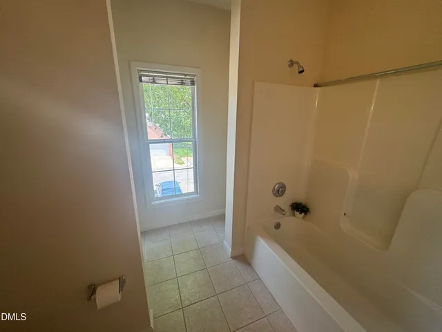 a bathroom with a bathtub and shower