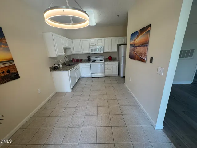 a kitchen with a sink a stove and cabinets