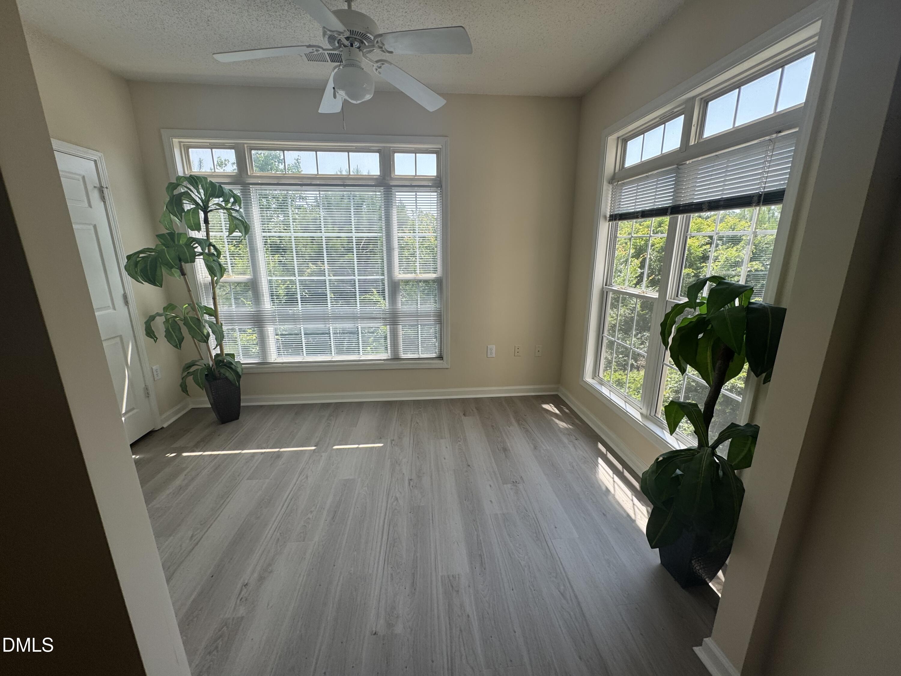 2520 Friedland Place, Unit 202 Raleigh, NC 27617 - Photo 7 of 14 wooden floor in an empty room with a window