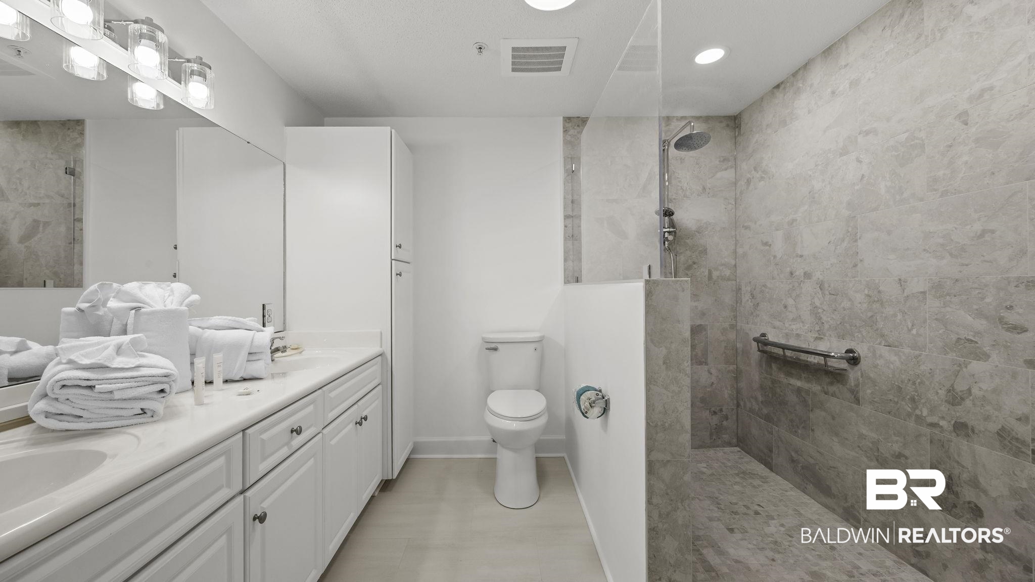 27580 Canal Road, Unit 1213 Orange Beach, AL 36561 - Photo 10 of 27 Bathroom featuring a dual-sink vanity with white cabinetry and a light-colored countertop