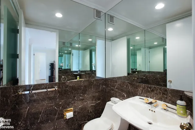 a bathroom with a granite countertop sink mirror and shower