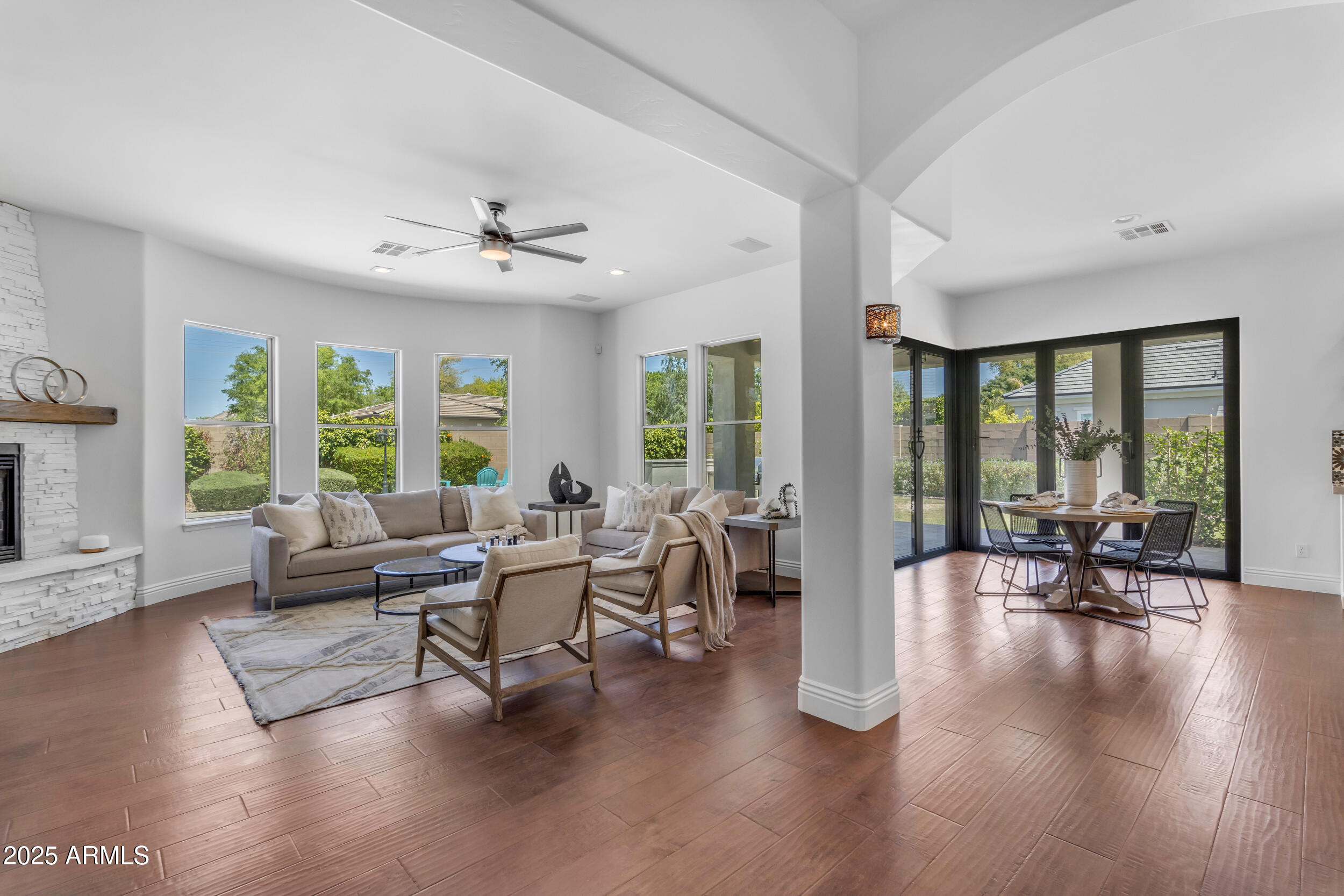 2820 Page Court Gilbert, AZ 85234 - Photo 25 of 109 a living room with furniture floor to ceiling window and wooden floor