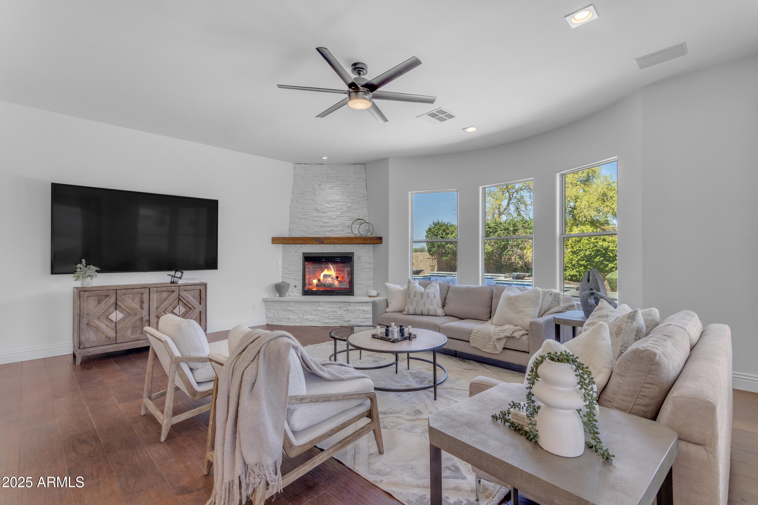 2820 Page Court Gilbert, AZ 85234 - Photo 27 of 109 a living room with furniture a flat screen tv and a fireplace