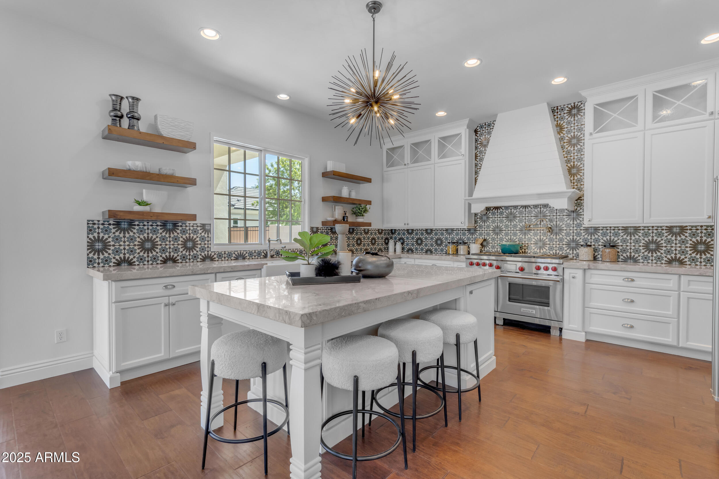 2820 Page Court Gilbert, AZ 85234 - Photo 32 of 109 a kitchen with white cabinets stainless steel appliances and kitchen island
