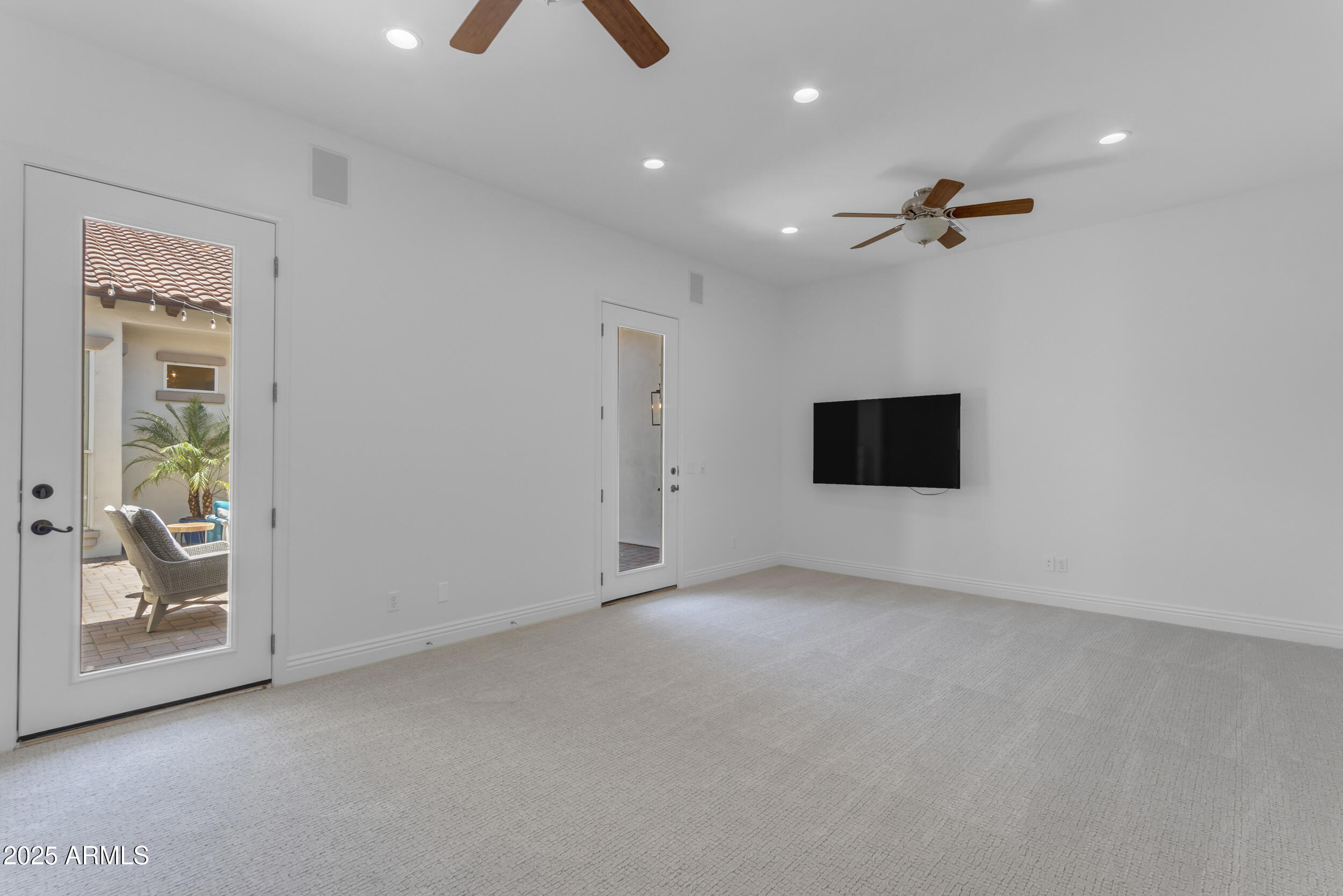 2820 Page Court Gilbert, AZ 85234 - Photo 51 of 109 an empty room with windows and a ceiling fan