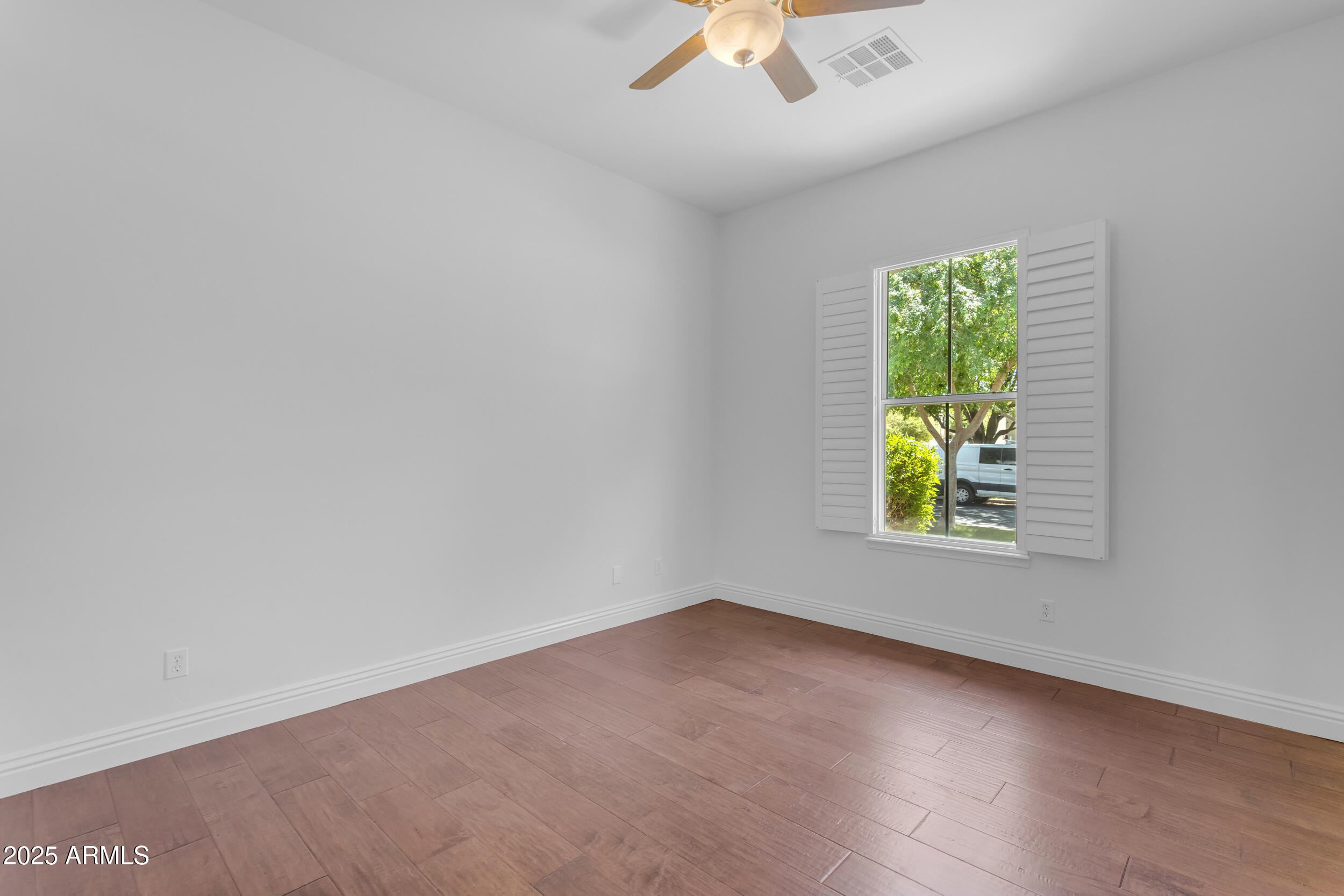 2820 Page Court Gilbert, AZ 85234 - Photo 61 of 109 an empty room with a window and a ceiling fan