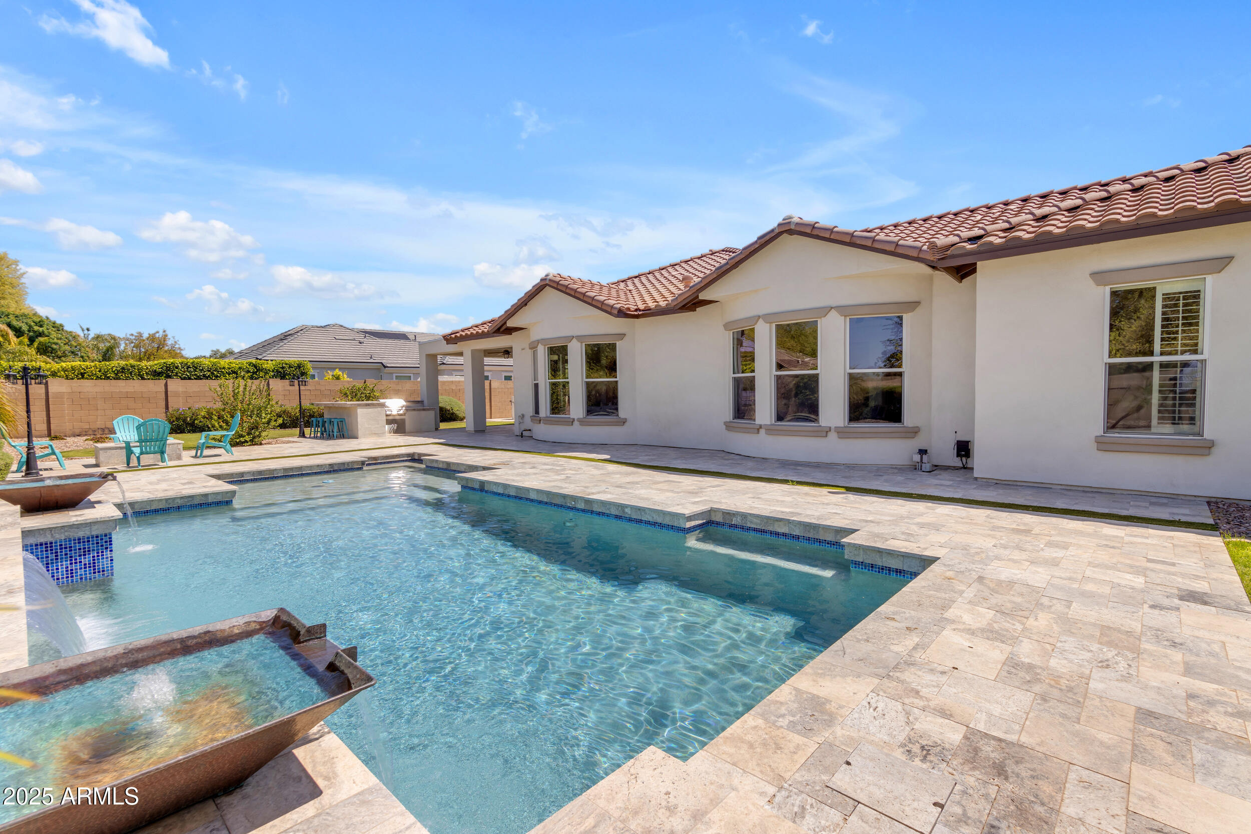 2820 Page Court Gilbert, AZ 85234 - Photo 82 of 109 a view of a house with pool and chairs