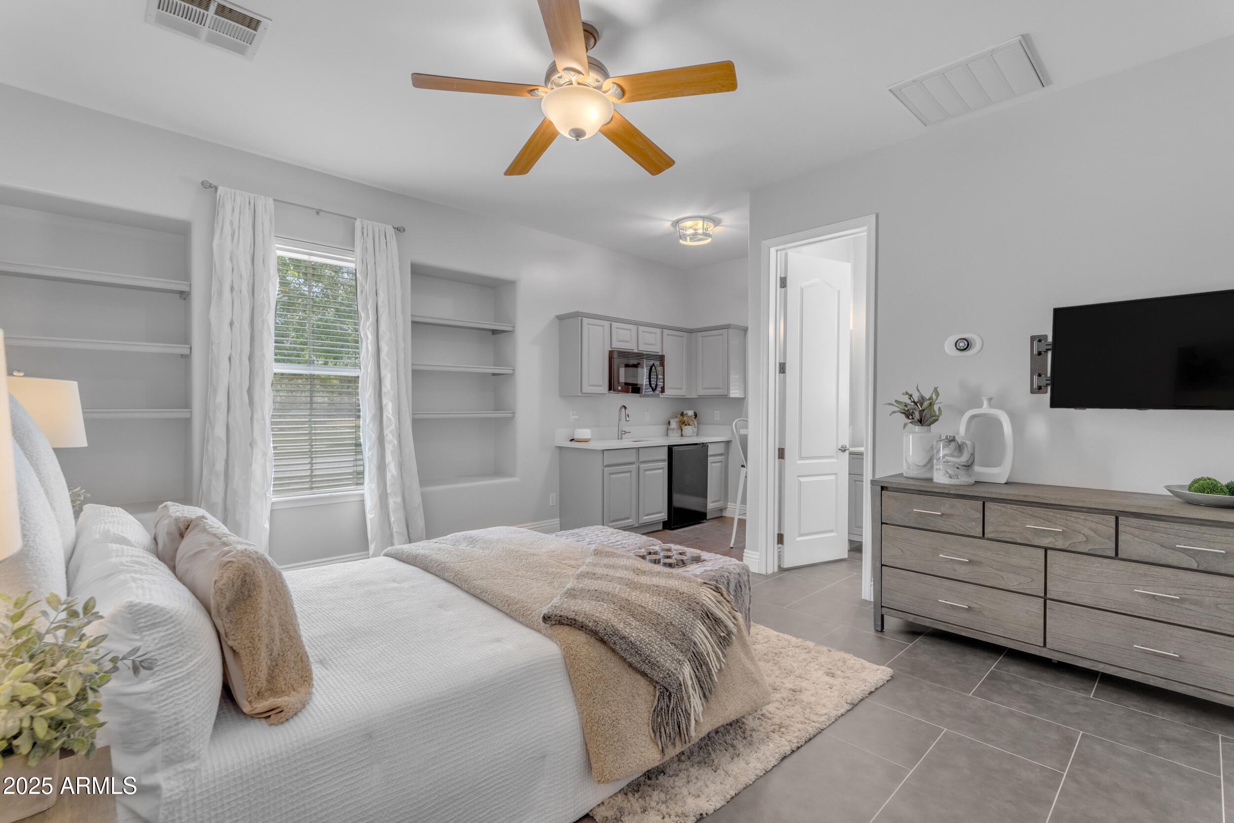 2820 Page Court Gilbert, AZ 85234 - Photo 6 of 109 a bedroom with a bed and a flat screen tv