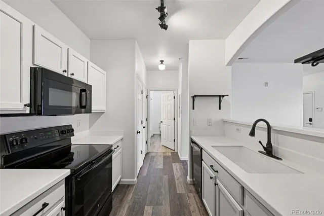 a kitchen with a sink stainless steel appliances and cabinets