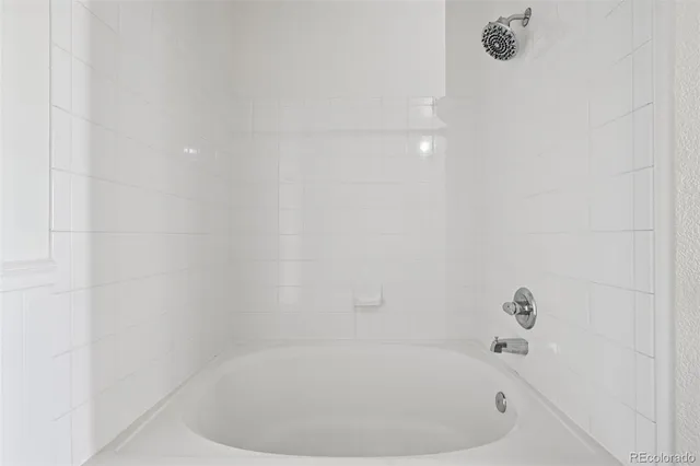 a white bath tub sitting in a bathroom