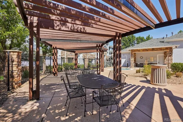 a view of a patio with a table chairs and a backyard