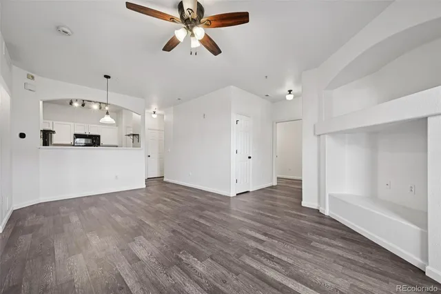 a view of a kitchen with a sink and a refrigerator