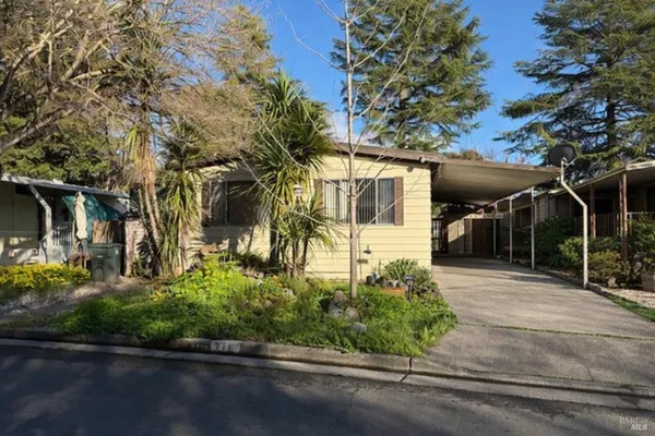 a front view of a house with a yard garage and outdoor seating