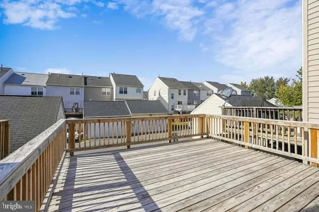 a view of a house with a wooden deck