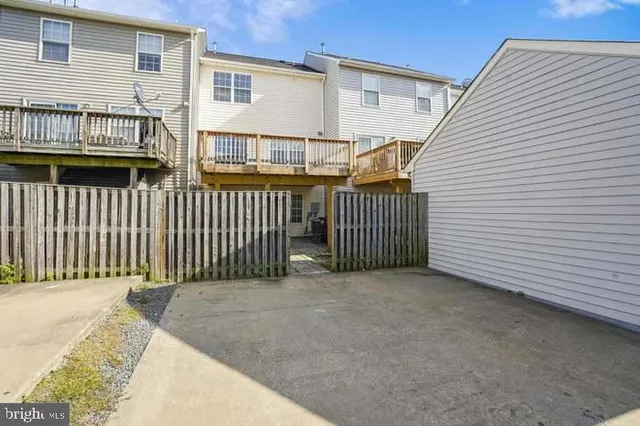 a view of a house with wooden fence