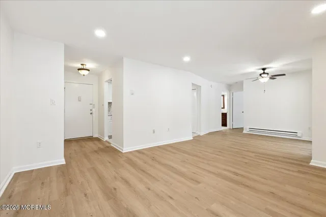 a view of an empty room with wooden floor