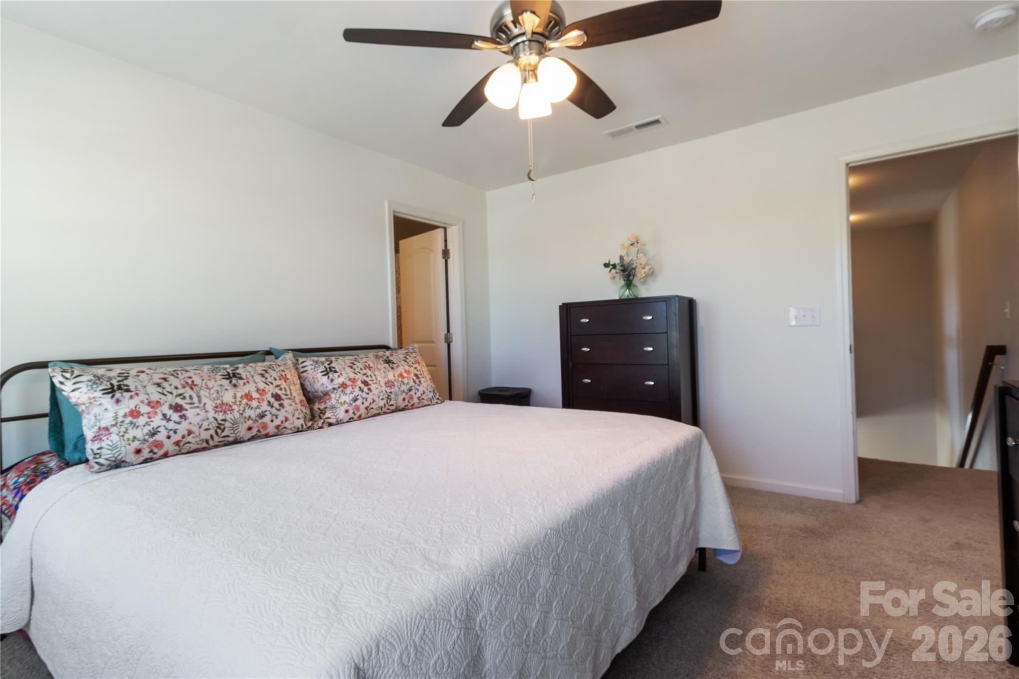 905 Alta Way Kannapolis, NC 28081 - Photo 12 of 24 a bedroom with a bed and a chandelier