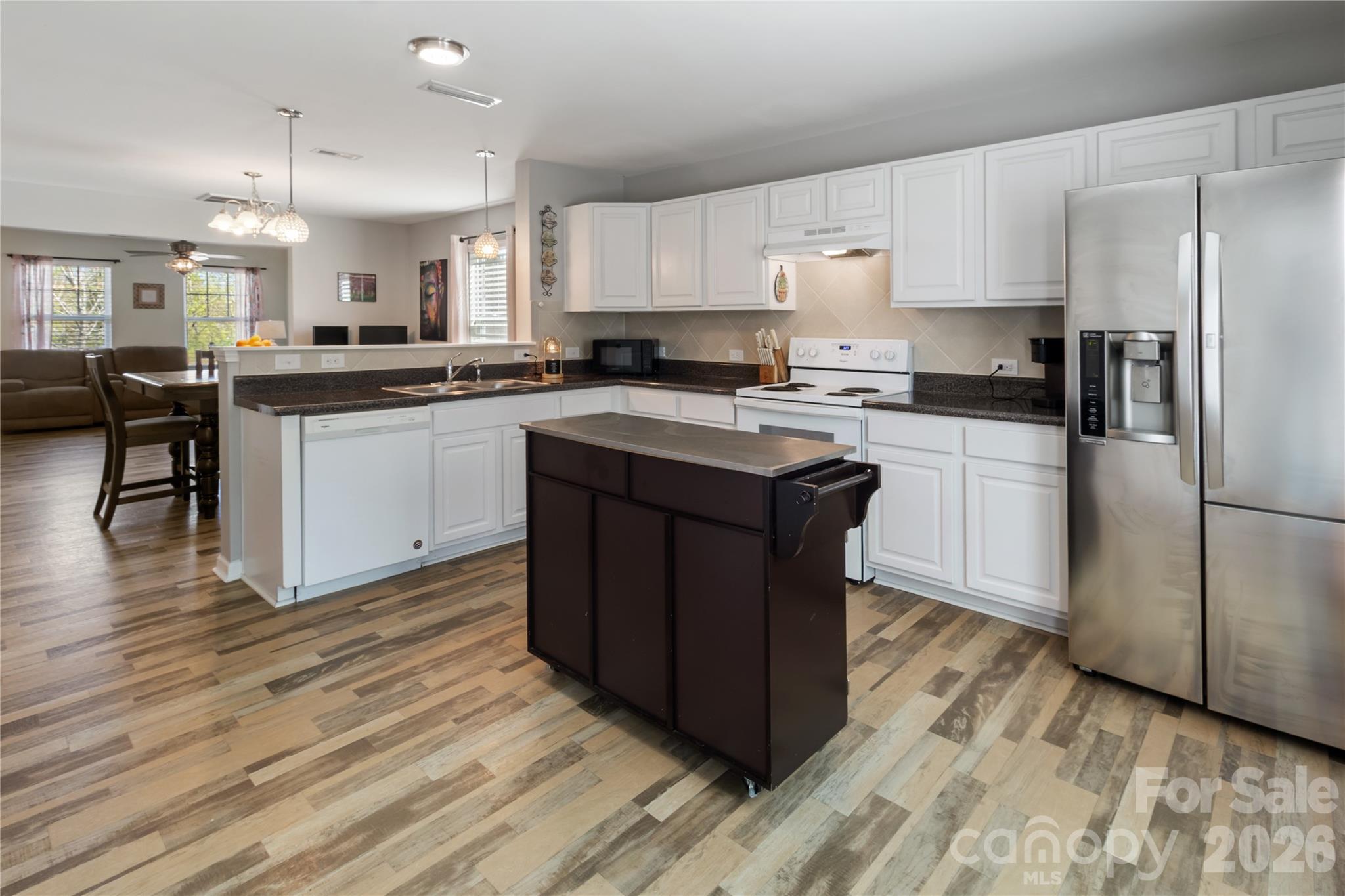 905 Alta Way Kannapolis, NC 28081 - Photo 9 of 24 a kitchen with a sink a refrigerator and cabinets