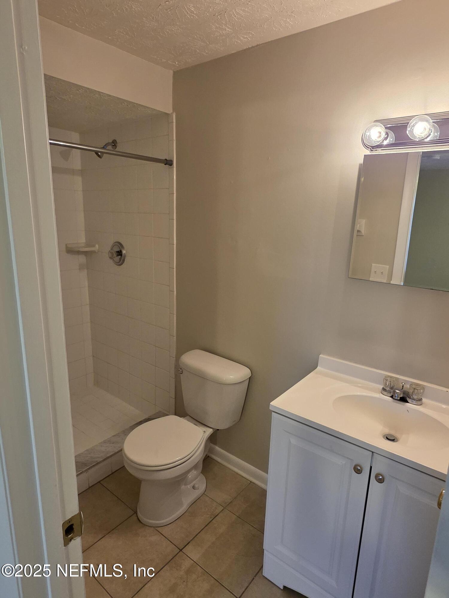 1143 Tumbleweed Drive Orange Park, FL 32065 - Photo 13 of 15 a white toilet sitting next to a bathroom sink