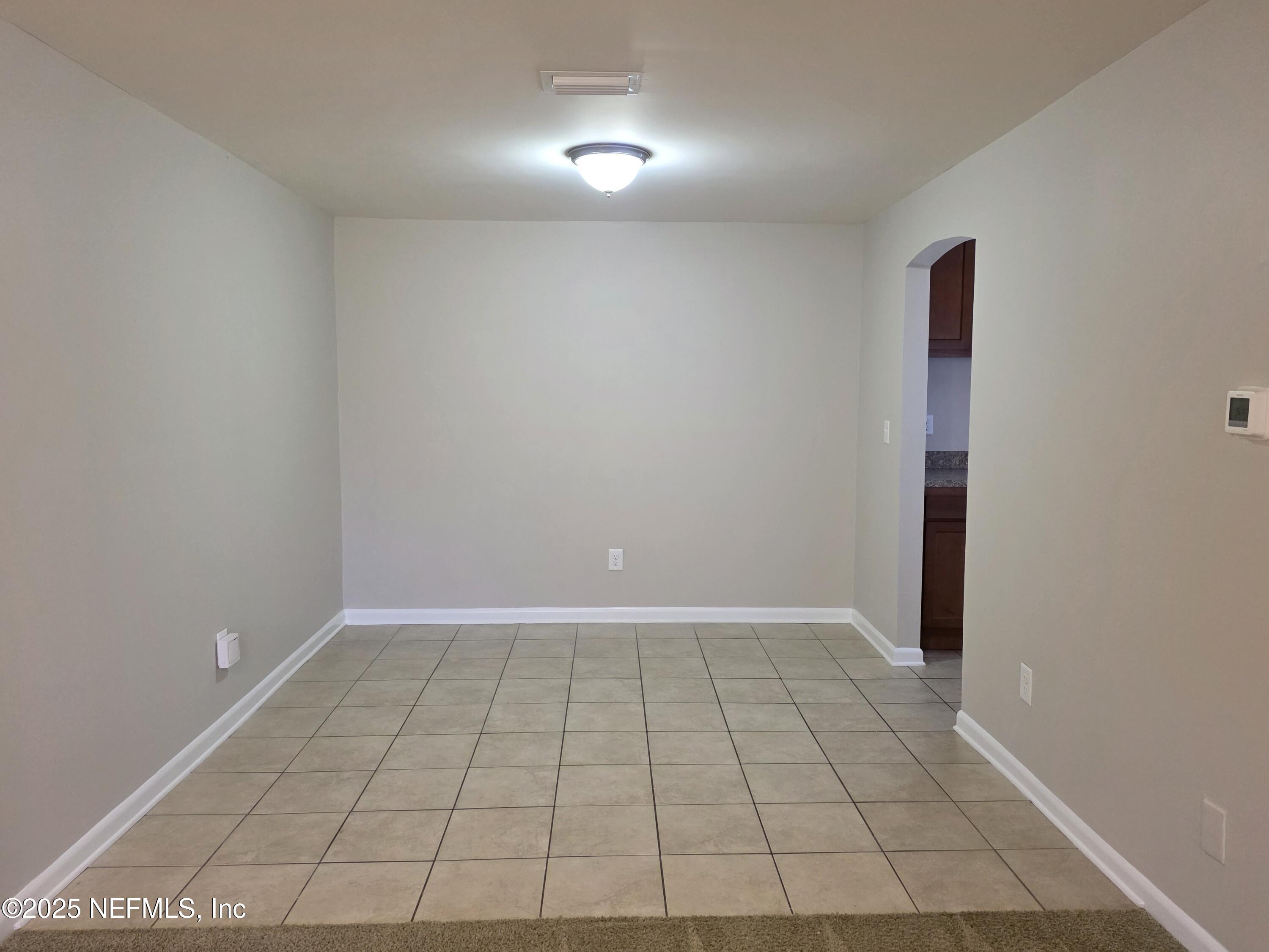 1143 Tumbleweed Drive Orange Park, FL 32065 - Photo 4 of 15 wooden floor in an empty room with a window