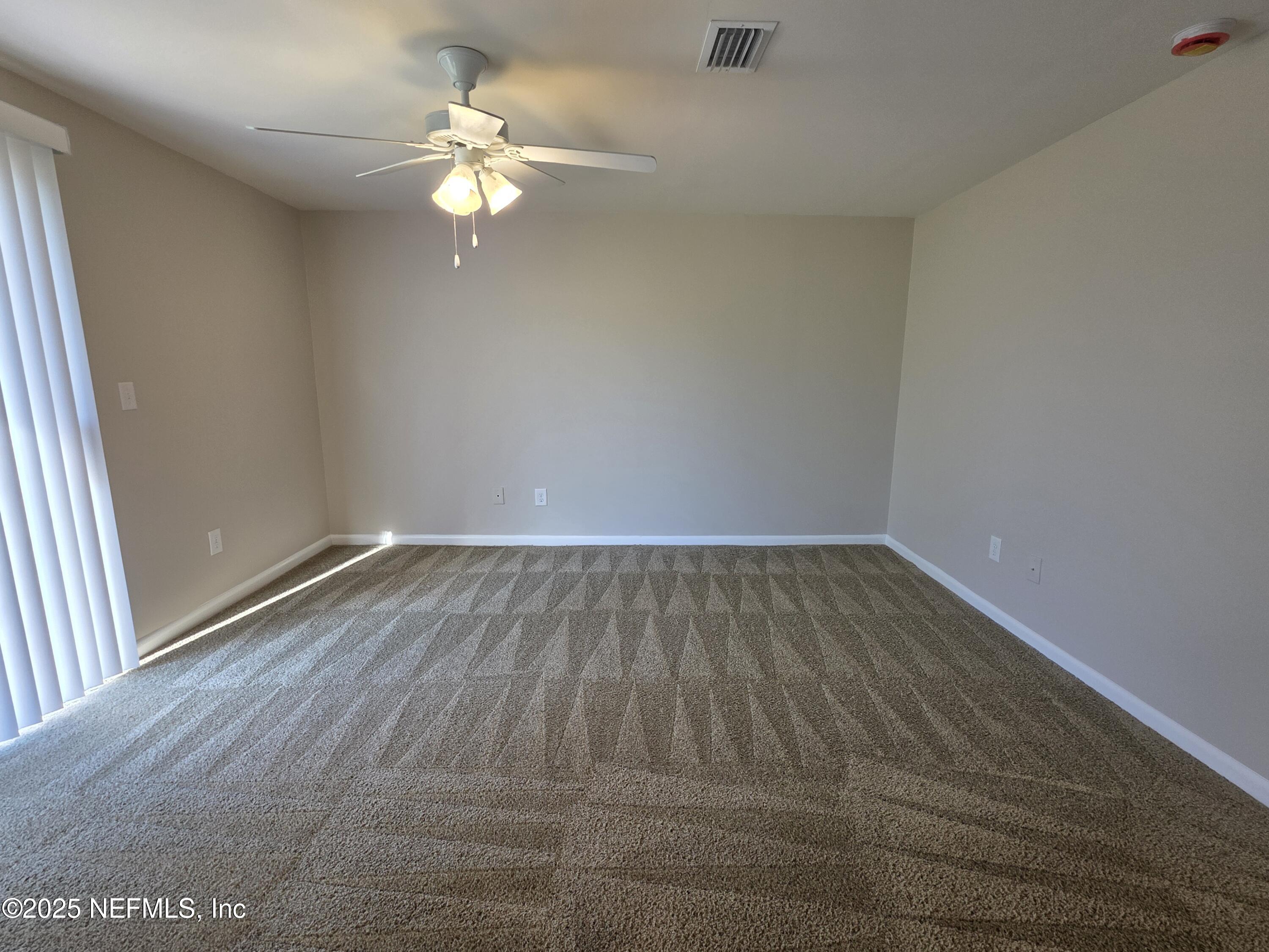 1143 Tumbleweed Drive Orange Park, FL 32065 - Photo 5 of 15 wooden floor in an empty room with a window