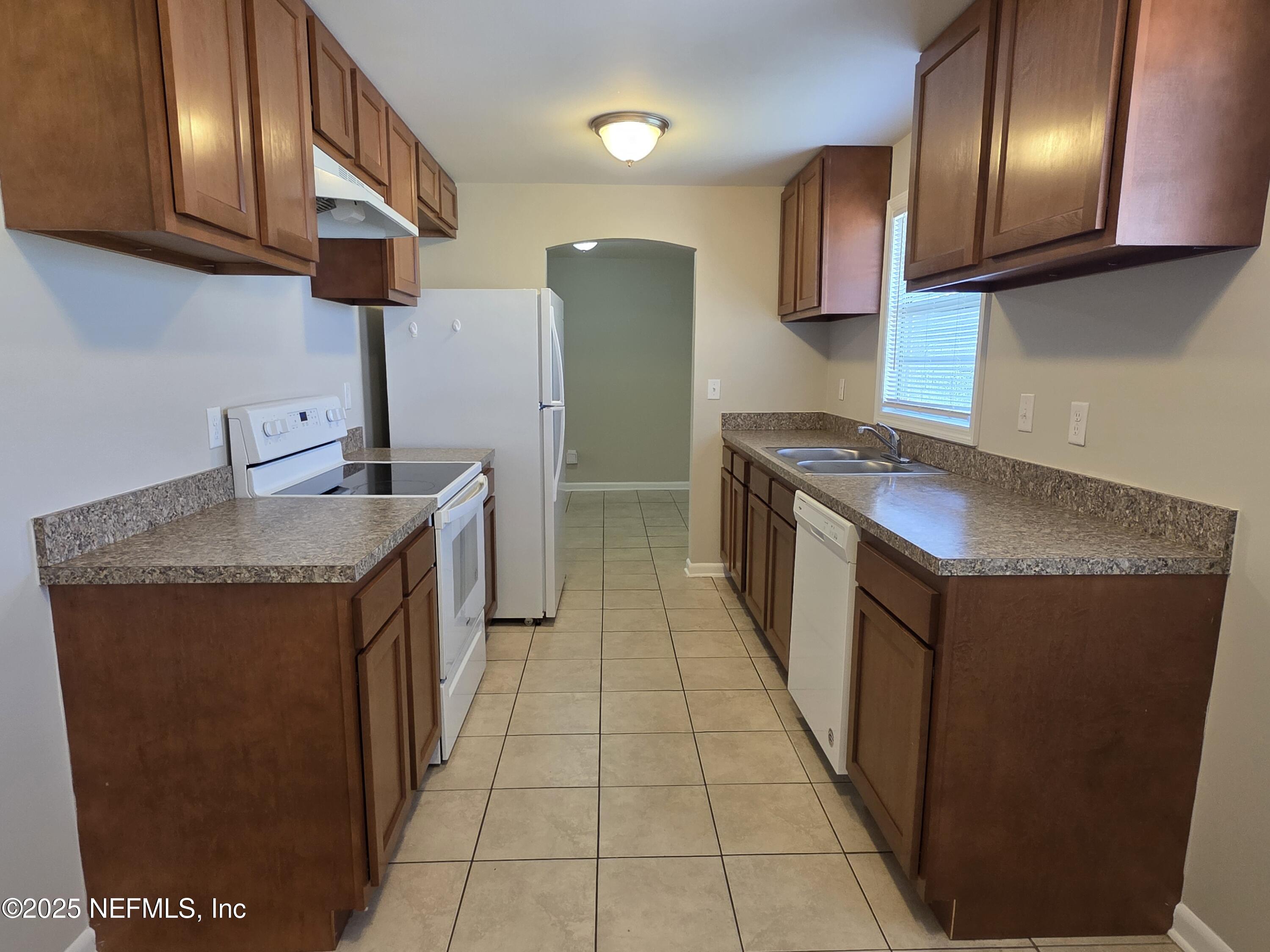 1143 Tumbleweed Drive Orange Park, FL 32065 - Photo 7 of 15 a kitchen with granite countertop cabinets stainless steel appliances and a sink
