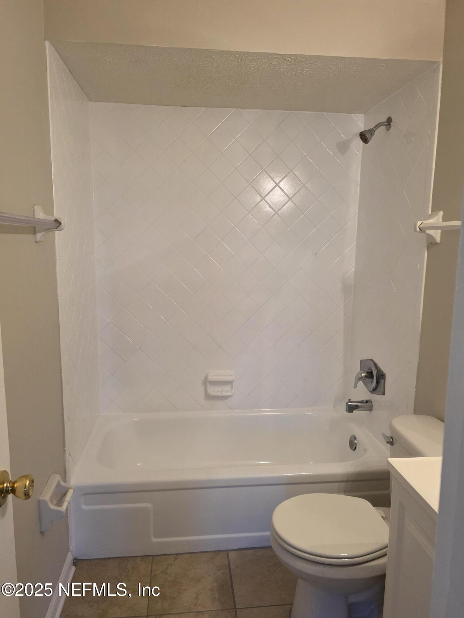 1143 Tumbleweed Drive Orange Park, FL 32065 - Photo 9 of 15 a bathroom with a toilet and a bath tub