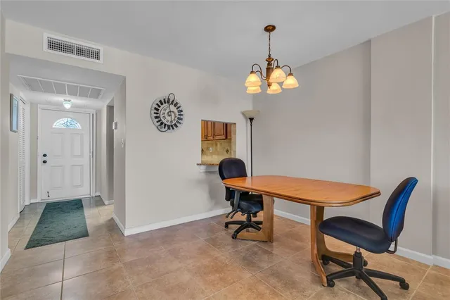 a view of a dining room with furniture and chandelier