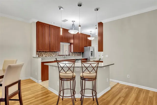 a view of kitchen with furniture and chandelier