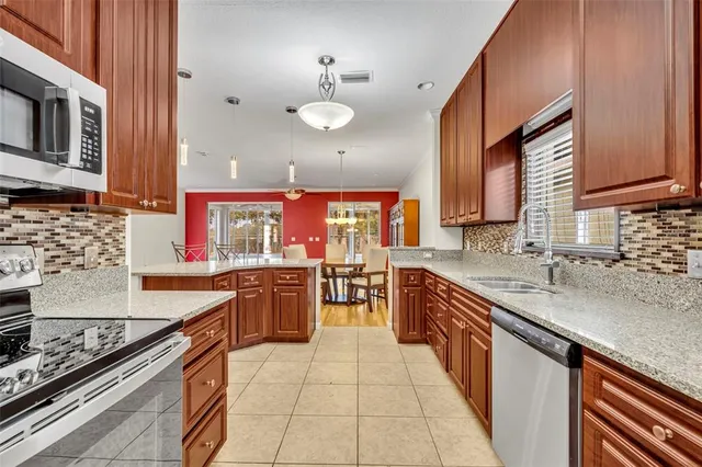 a kitchen with a sink stove and cabinets