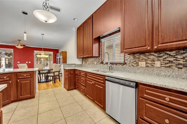 a kitchen with stainless steel appliances granite countertop wooden cabinets a sink and dishwasher