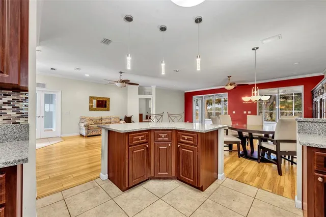 a large kitchen with kitchen island a sink table and chairs