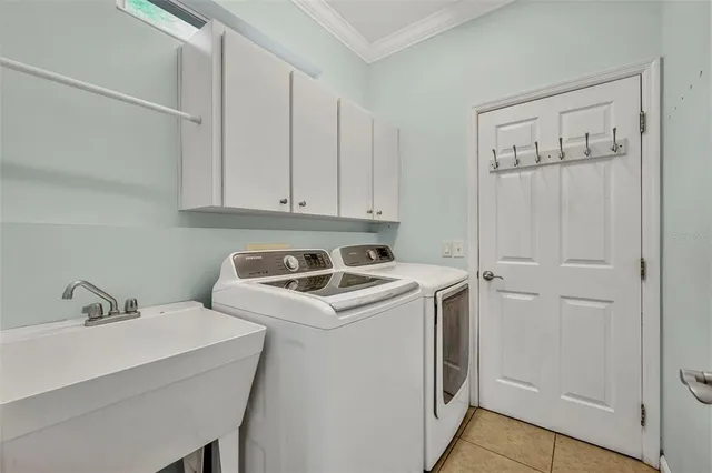 a view of a storage and utility room with washer and dryer