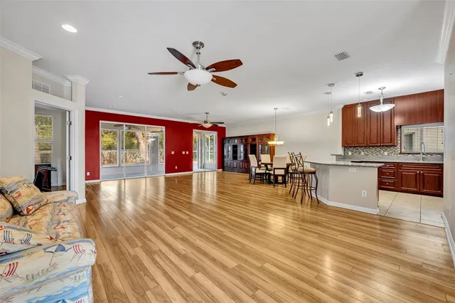 a view of a living room kitchen and a wooden floor