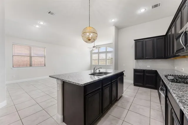 a kitchen with stainless steel appliances granite countertop a sink and cabinets