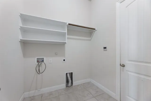 an empty room with ceiling fan and window