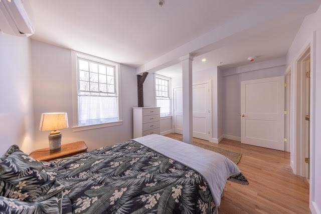 10 Deerfield Avenue, Unit 5 Shelburne, MA 01370 - Photo 14 of 28 a bedroom with a bed and wooden floor