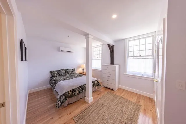 a bedroom with furniture and a window