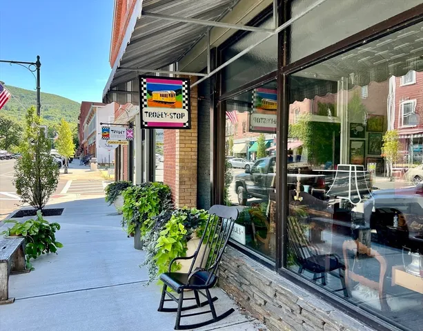 a view of a roof deck with chair and wooden floor