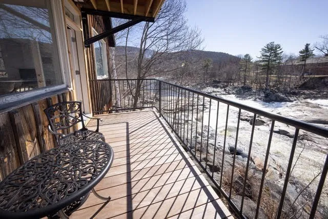 a view of balcony with wooden floor