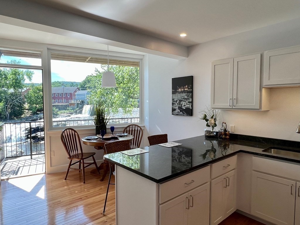 10 Deerfield Avenue, Unit 5 Shelburne, MA 01370 - Photo 4 of 28 a kitchen with granite countertop a sink and white cabinets