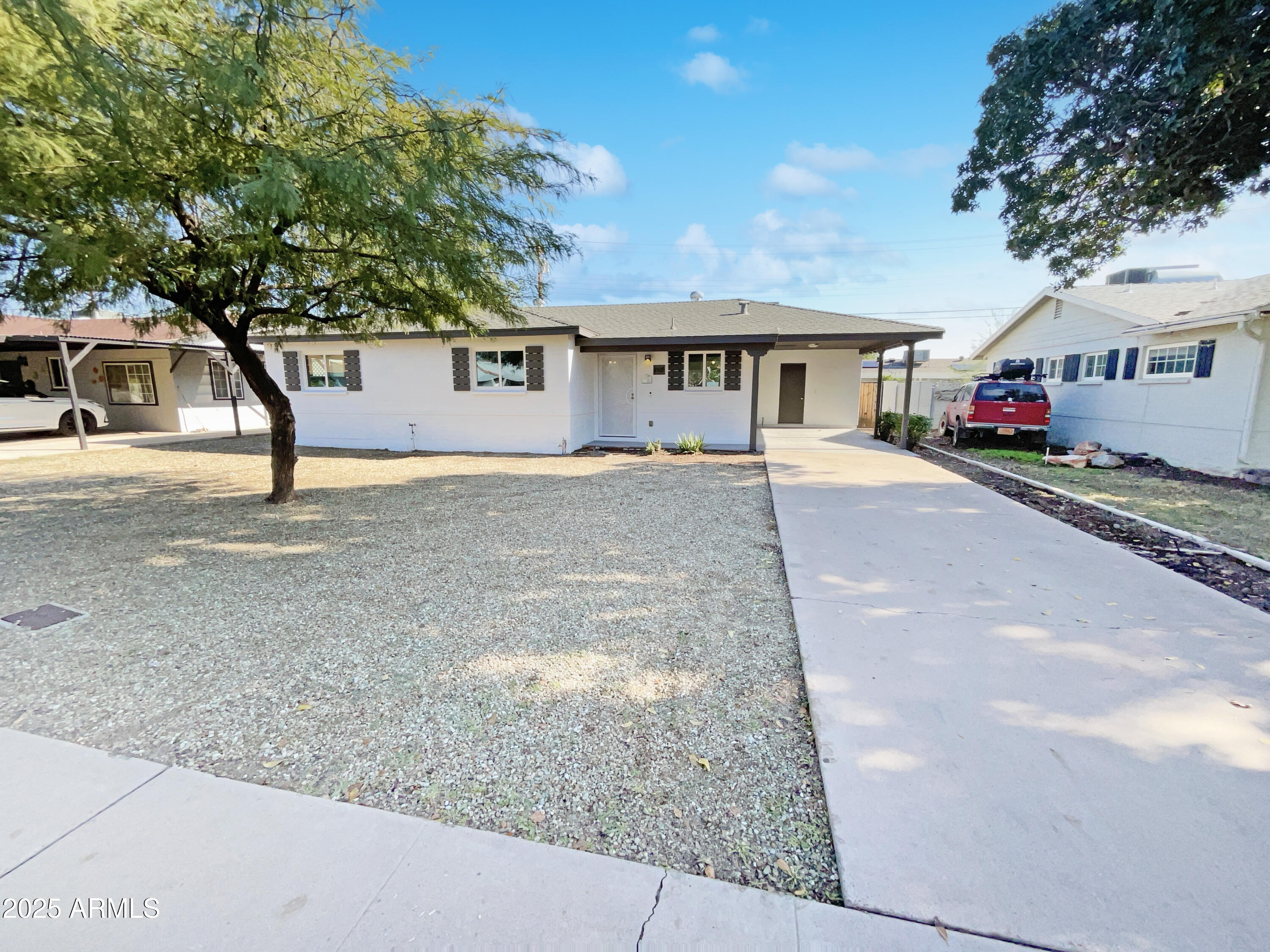 7231 North 23rd Avenue Phoenix, AZ 85021 - Photo 20 of 28 a front view of a house with a yard and garage