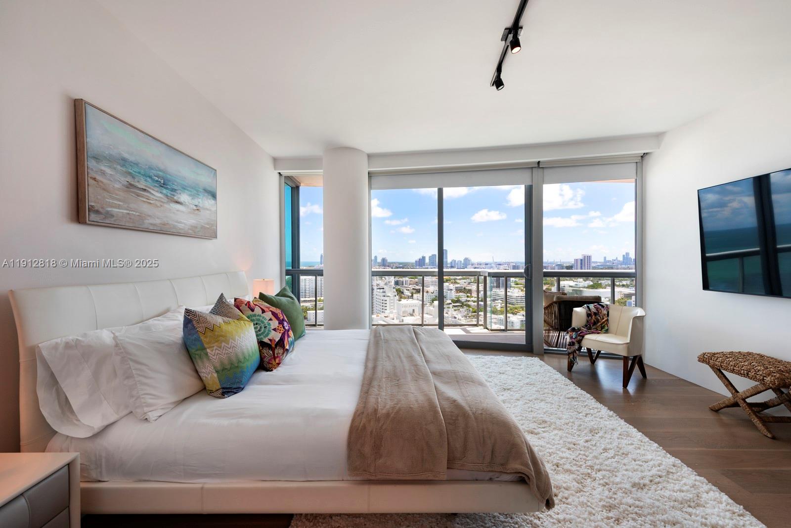 101 20th Street, Unit 3006 Miami Beach, FL 33139 - Photo 11 of 18 a bedroom with a bed and a large window