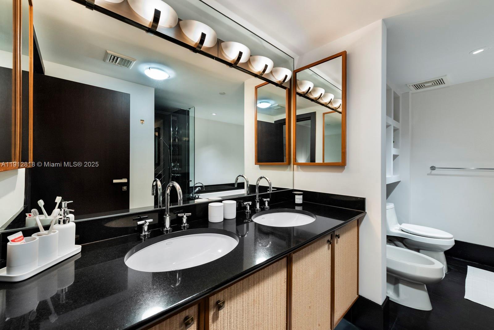 101 20th Street, Unit 3006 Miami Beach, FL 33139 - Photo 12 of 18 a bathroom with a sink and a mirror