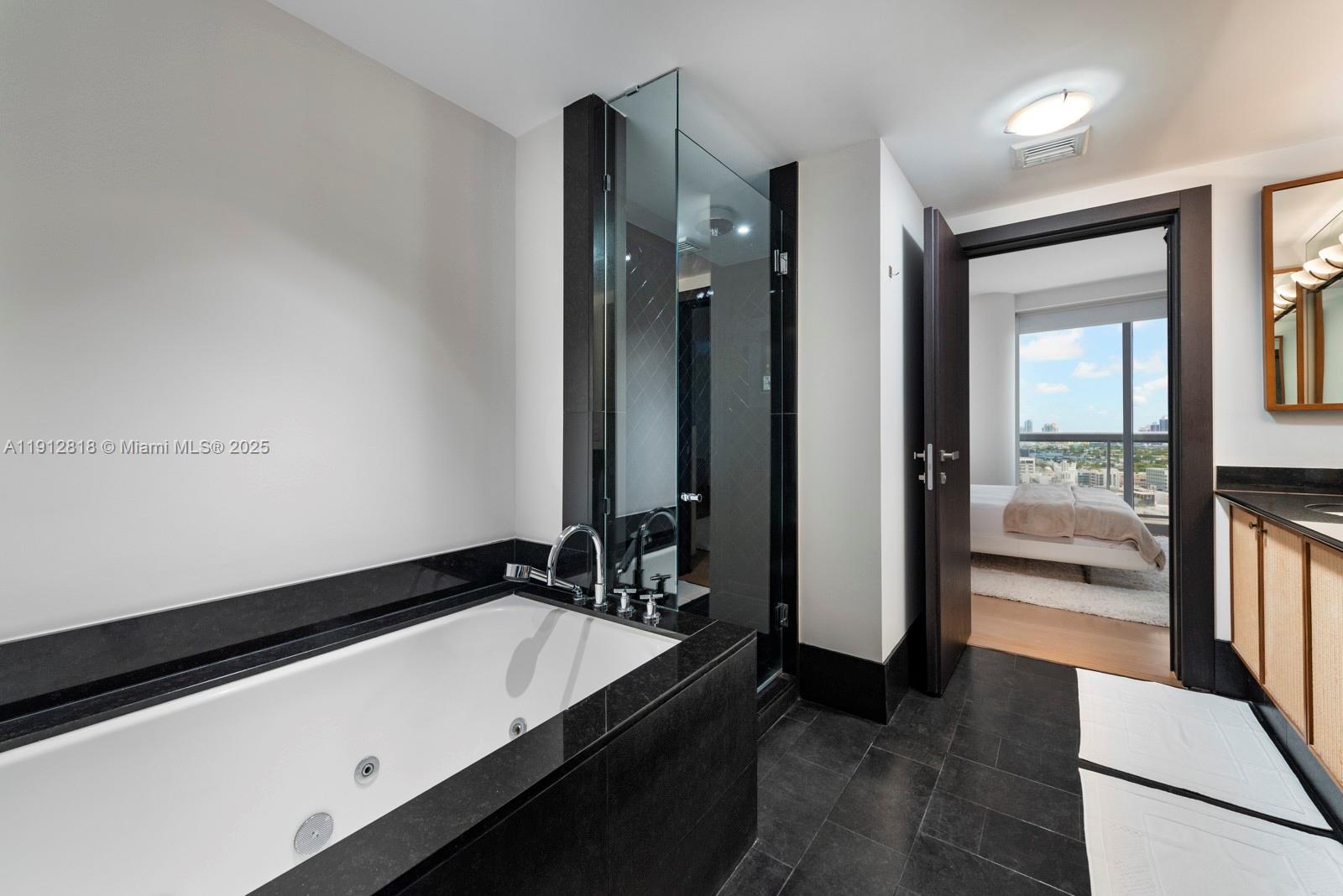 101 20th Street, Unit 3006 Miami Beach, FL 33139 - Photo 14 of 18 a bathroom with a sink and a mirror