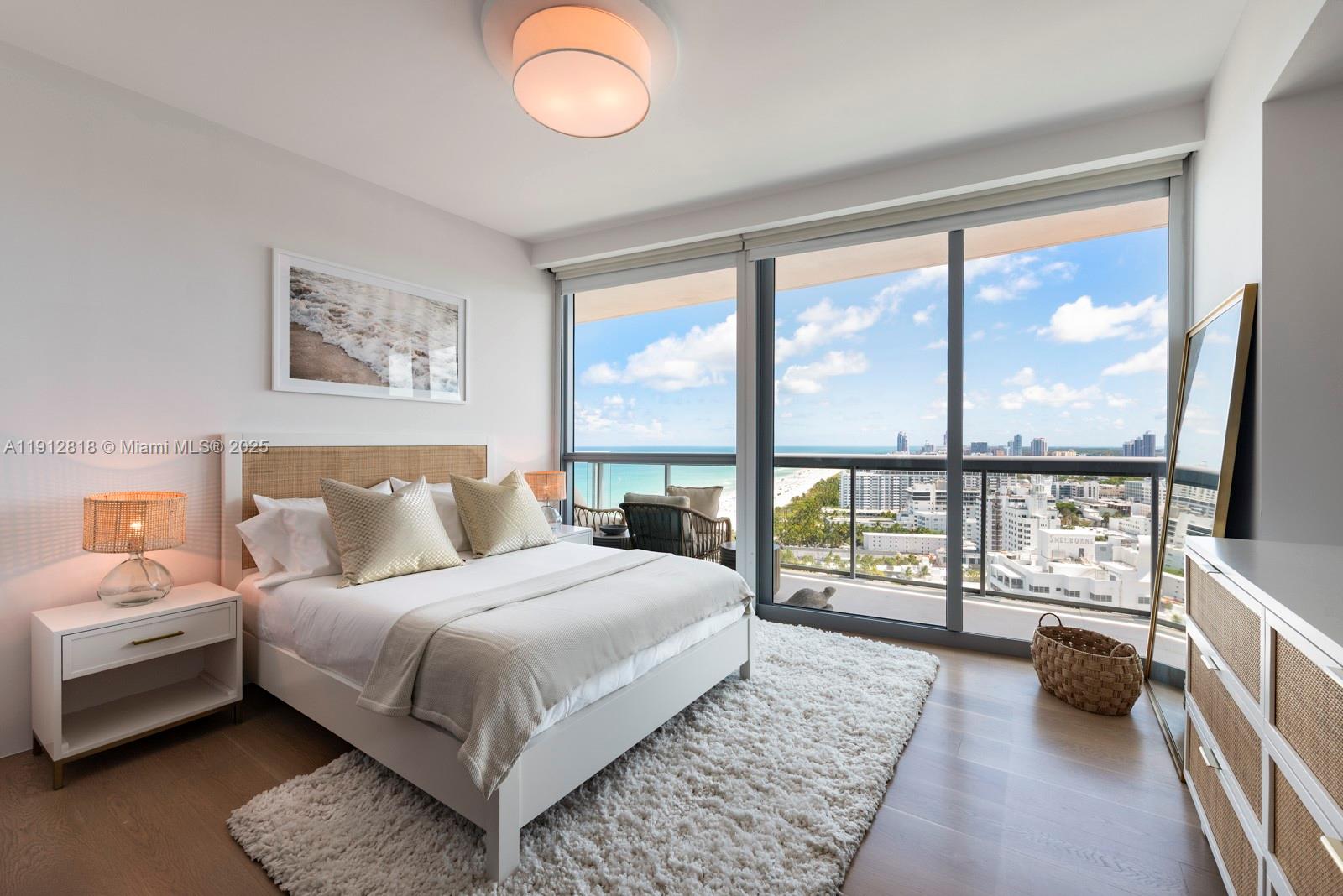 101 20th Street, Unit 3006 Miami Beach, FL 33139 - Photo 16 of 18 a bedroom with a large bed and a large window
